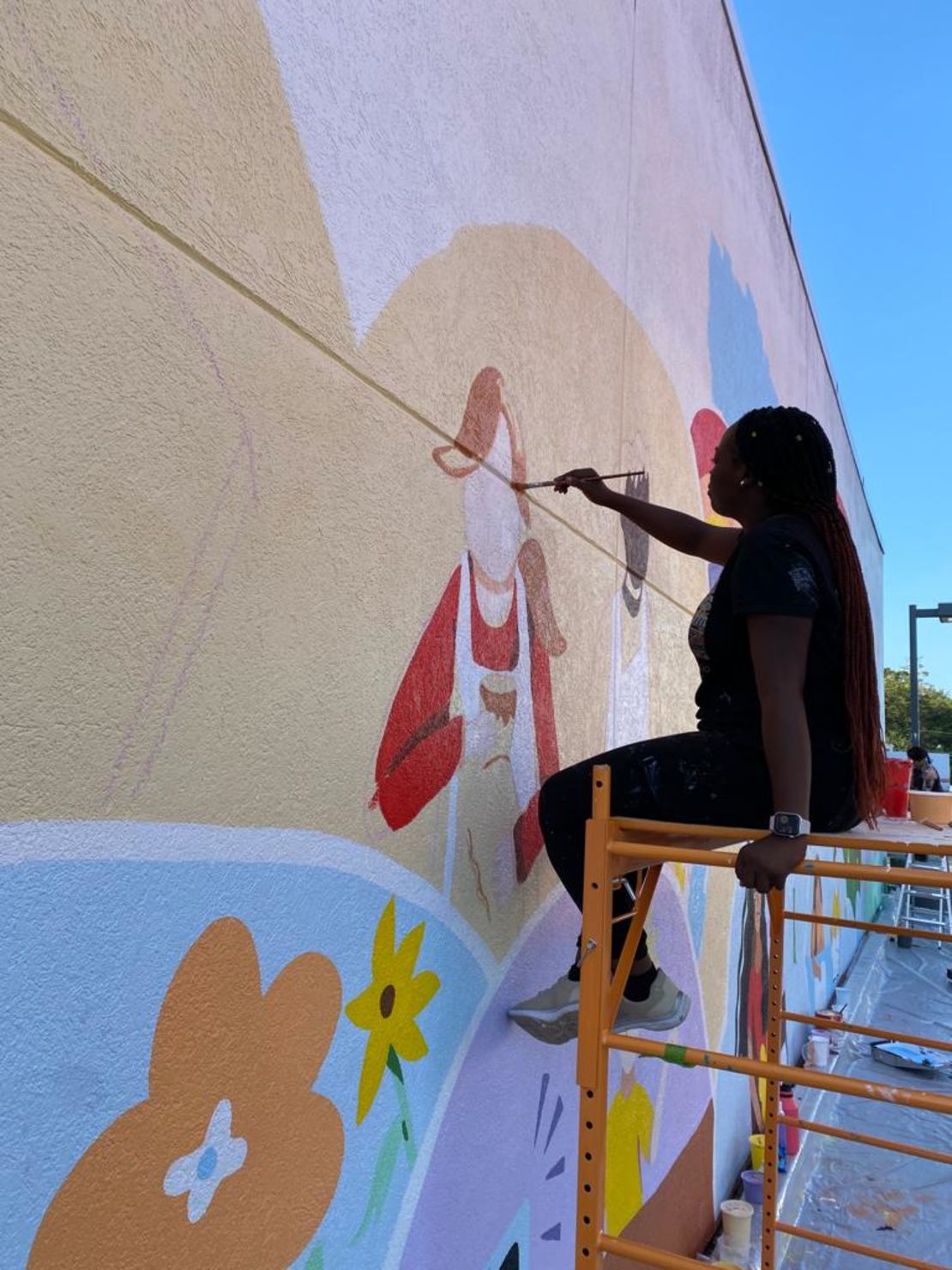 Marie Saint-Cyr painting a mural at SIBSPlace in 2023 in Rockville Centre, New York.